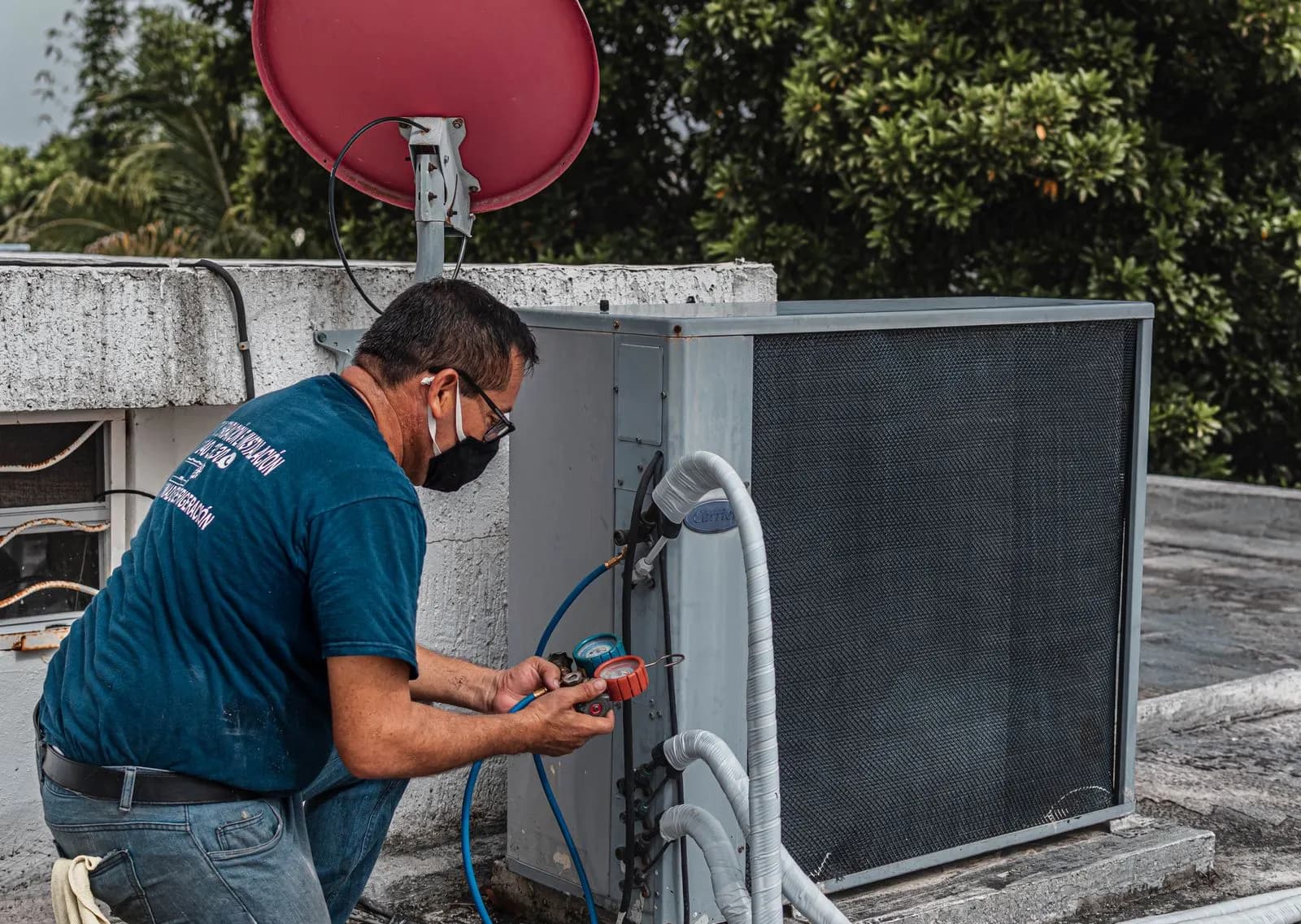 Technician testing an outdoor condensing unit